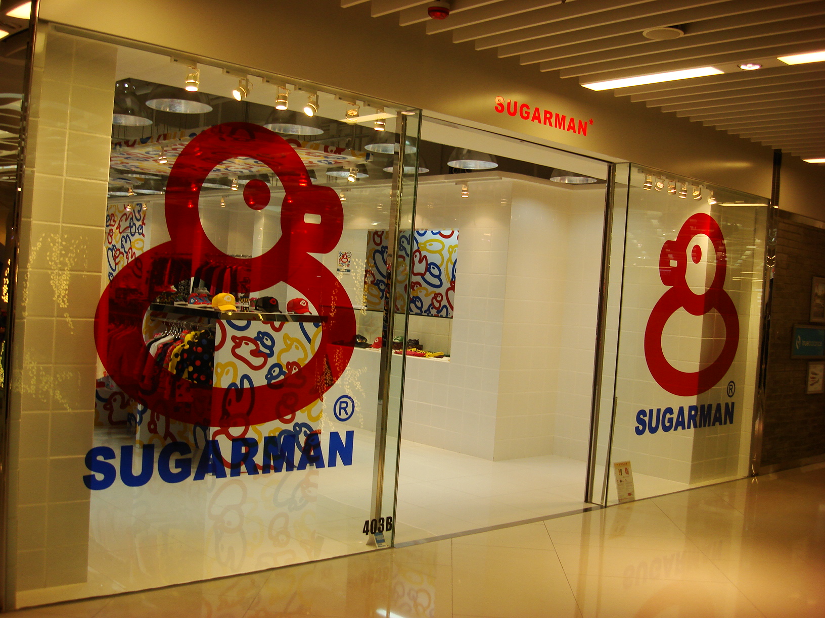 Standard retail storefront entrance with glass facade and narrow commercial doorway suitable for lightweight Christmas entrance decoration