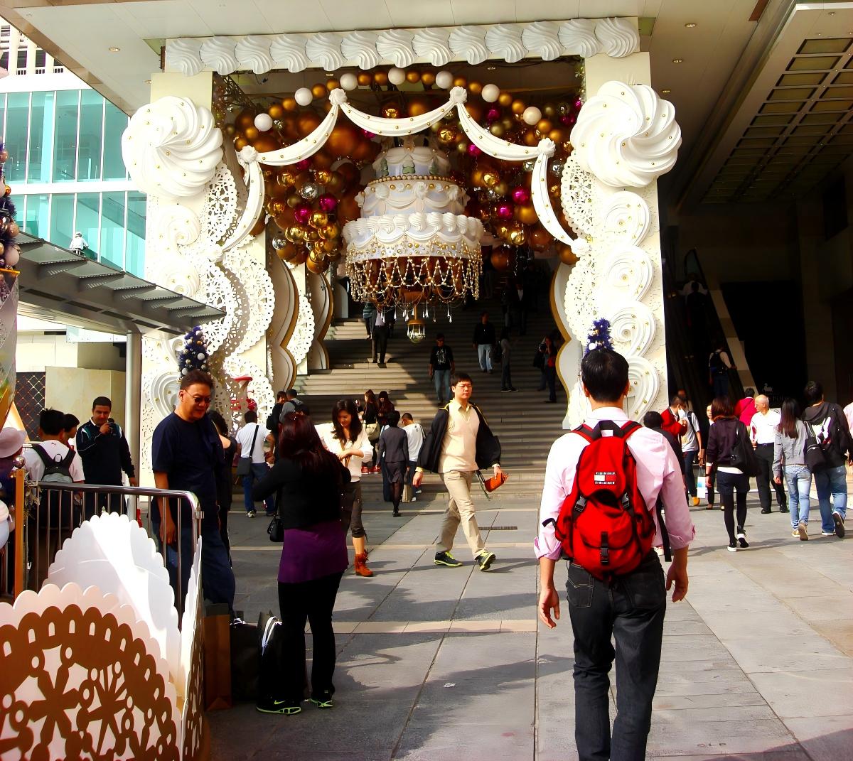 Large commercial Christmas entrance display with a themed decorative structure and open forecourt space for visitor flow and photo-taking