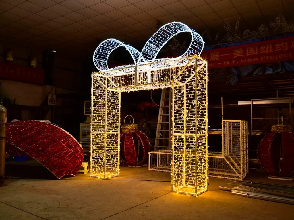 Illuminated gift-box-shaped arch with a rectangular opening photographed in a workshop