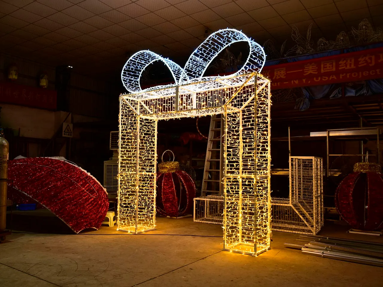 Illuminated gift-box-shaped arch with a rectangular opening photographed in a workshop