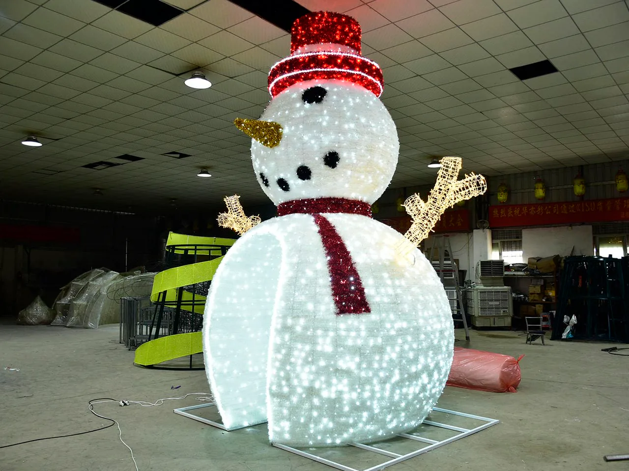 Illuminated snowman decoration photographed in a workshop