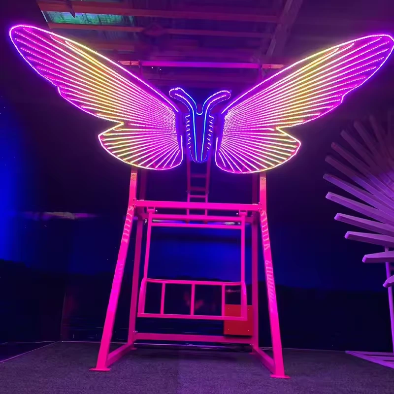 Multicolor illuminated butterfly wings above a suspended swing seat