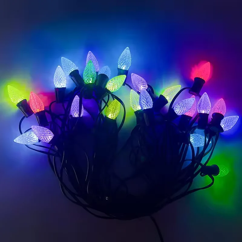 Illuminated multicolor Christmas bulb string on a dark background