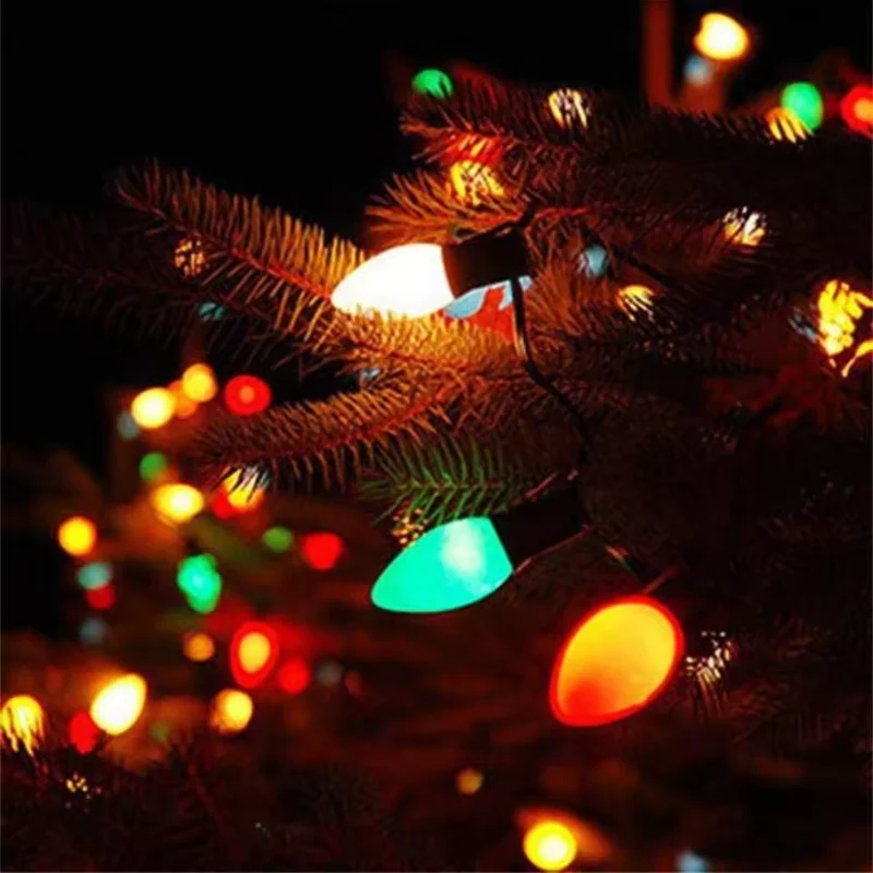 Multicolor C7 C9 style string lights decorating Christmas tree branches