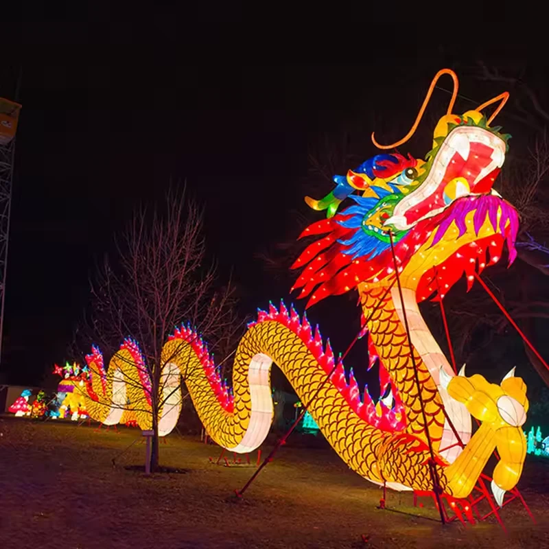 Close view of a colorful dragon head and illuminated lantern body