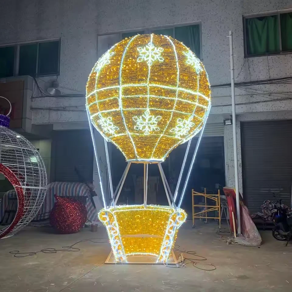 Giant golden hot air balloon light sculpture with snowflake motifs in the workshop