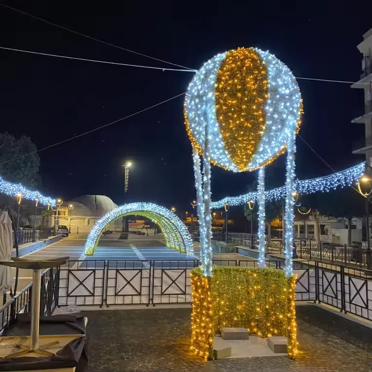 Gold and white illuminated balloon with basket in a commercial plaza