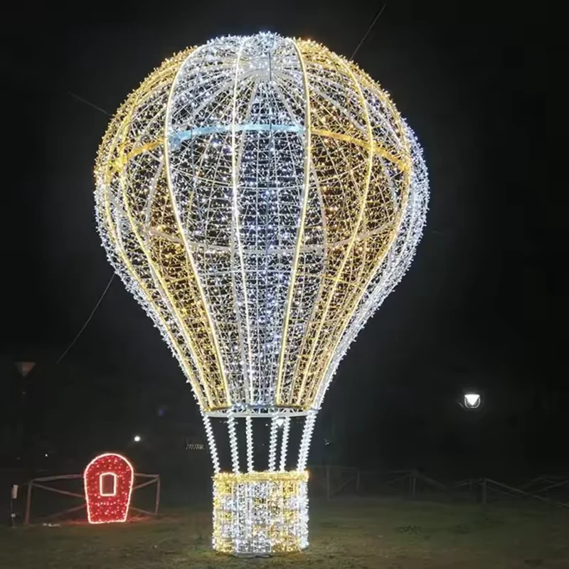 Large outdoor hot air balloon sculpture outlined with white LED lights