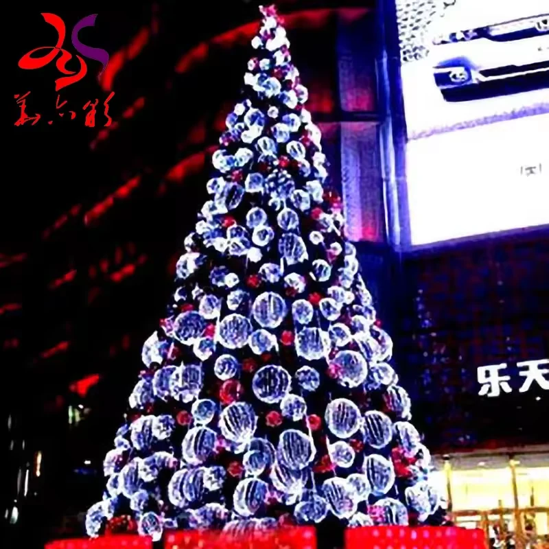 Giant commercial Christmas tree decorated with illuminated white baubles outside a shopping venue