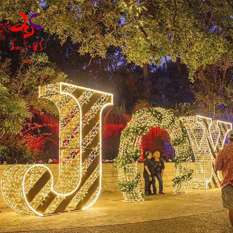 Giant warm white JOY letter lights with a circular O opening