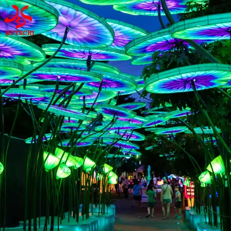 Visitors beneath a colorful lotus leaf light walkway