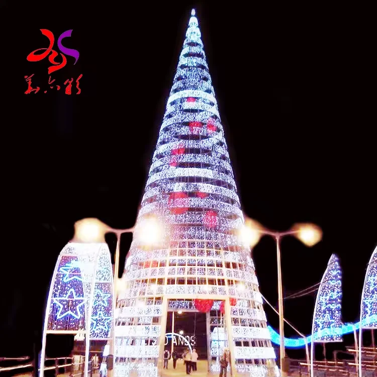 Tall open-frame Christmas light tree with horizontal illuminated bands and a public entrance