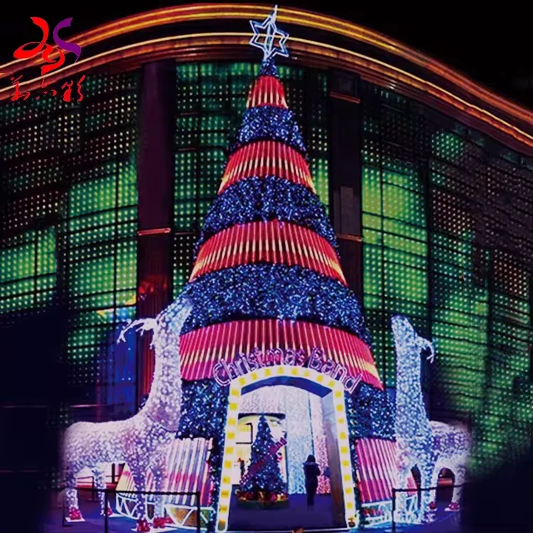 Commercial walk-in Christmas tree with red and blue light bands beside reindeer decorations