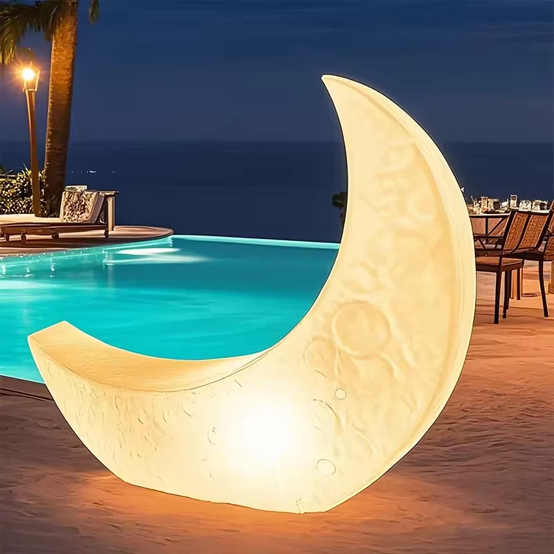 Warm illuminated crescent moon in a poolside design reference