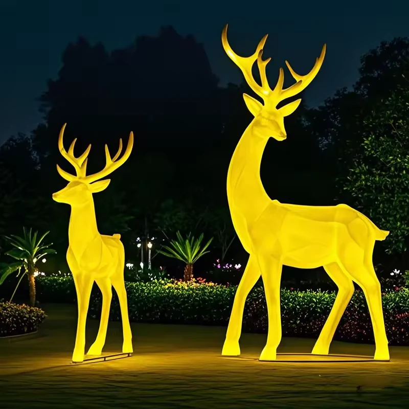 Internally illuminated deer pair in a commercial landscape setting