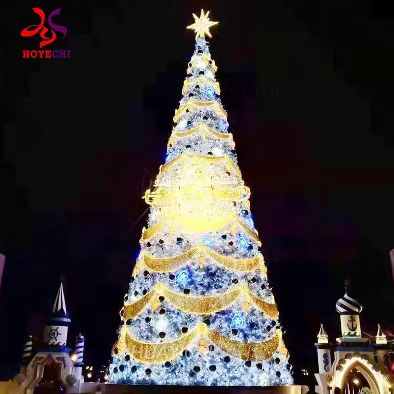 White and gold decorated Christmas tree with layered illuminated swags