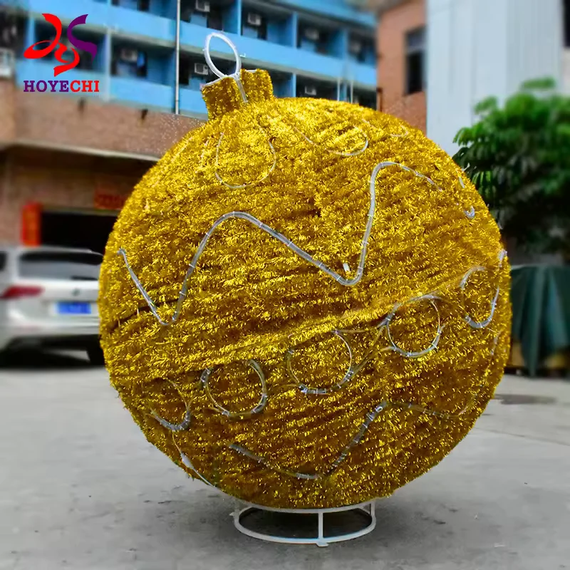 Gold decorative Christmas ball showing its metal base and unlit patterned surface