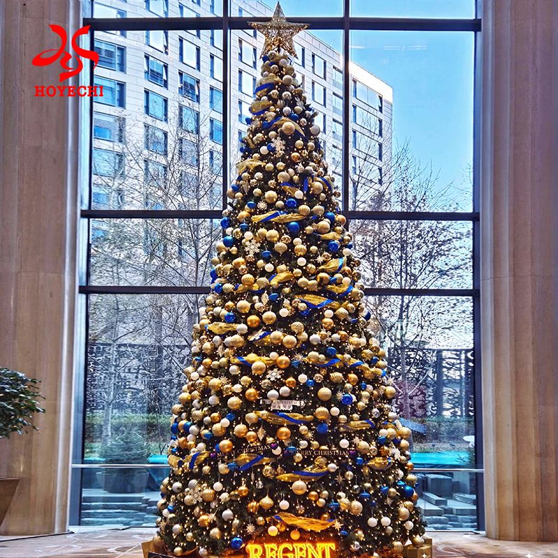 Luxury giant Christmas tree with gold ornaments for hotel lobby holiday decoration