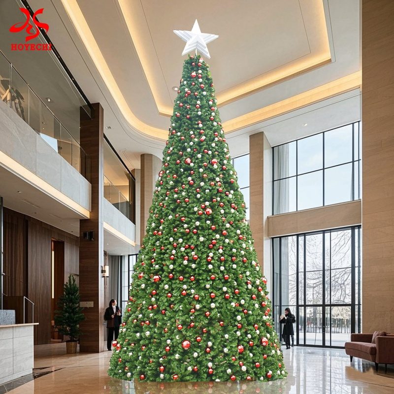 Large commercial Christmas tree displayed in a modern indoor lobby with ornaments and star topper.