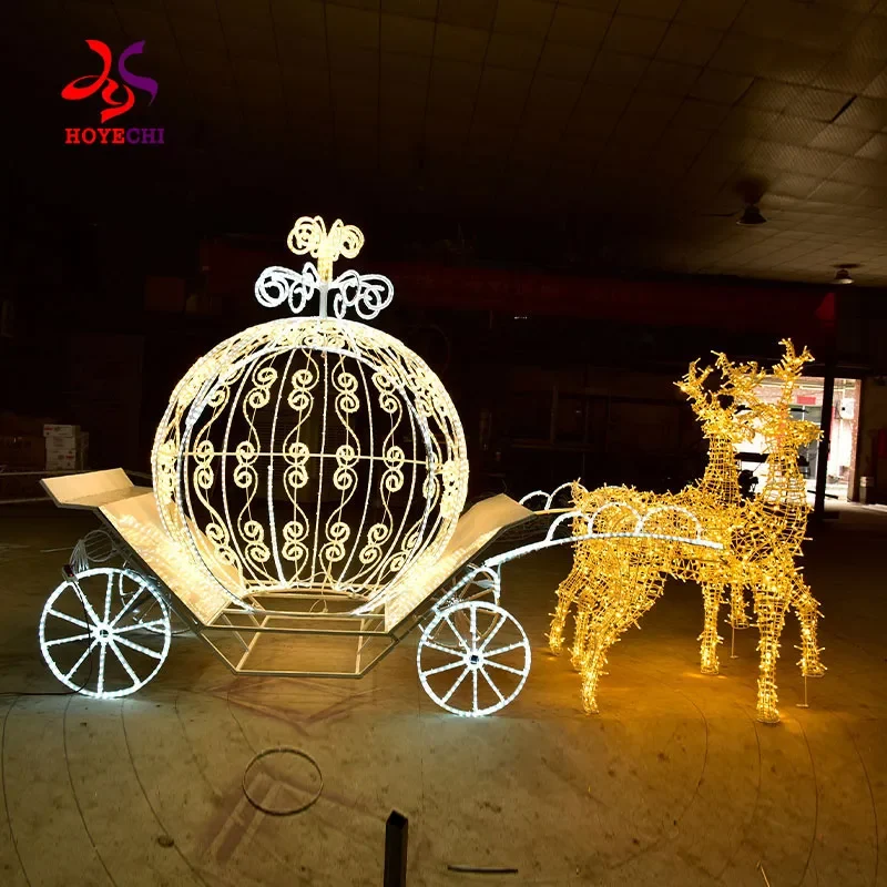 Illuminated reindeer and carriage display photographed in a dark workshop