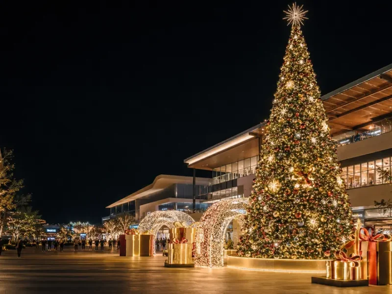 Commercial Christmas decoration solutions with a giant tree, light arches and gift box displays at a shopping mall