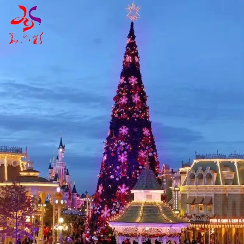 Giant commercial Christmas tree decorated with illuminated pink snowflake motifs
