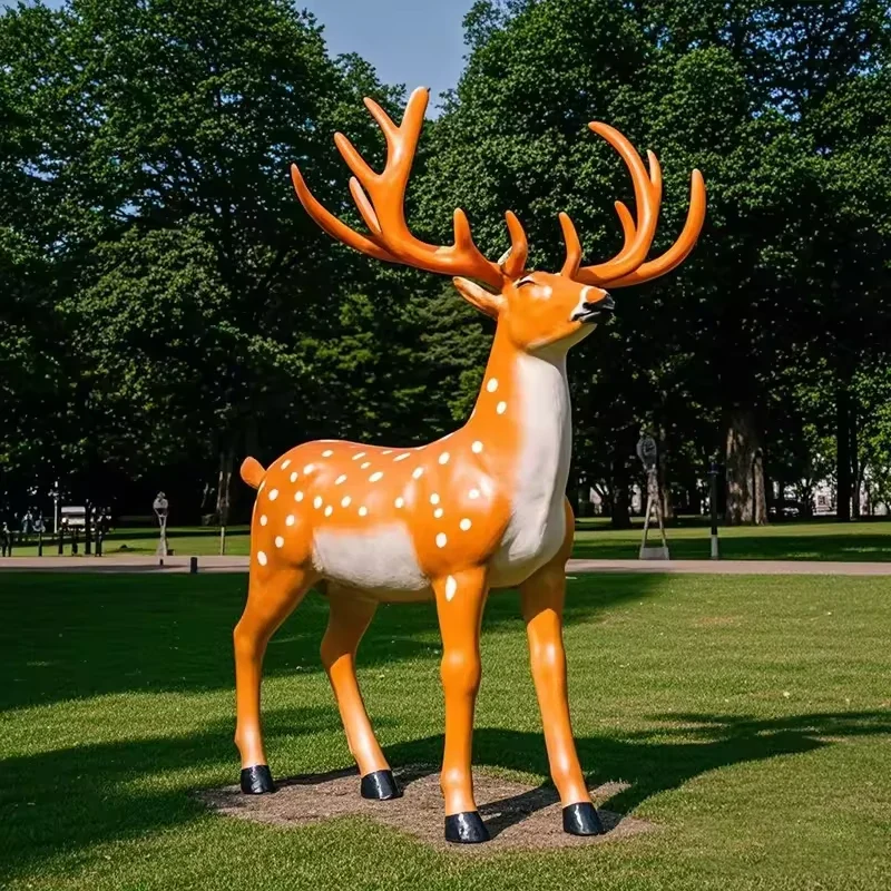 Orange spotted fiberglass deer sculpture shown in daylight